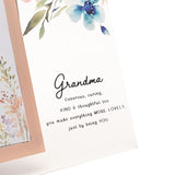 Close-up of the Grandma Floral and Bee Glass Photo Frame 6 x 4in, showing a peach-bordered photo opening beside blue watercolour flowers and the printed verse beneath "Grandma" in script.