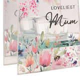 Close-up of the Loveliest Mum glass tealight candle holder, square clear glass panel with pink and blue floral print and a bee, mirrored back panel and glass tealight cups visible.