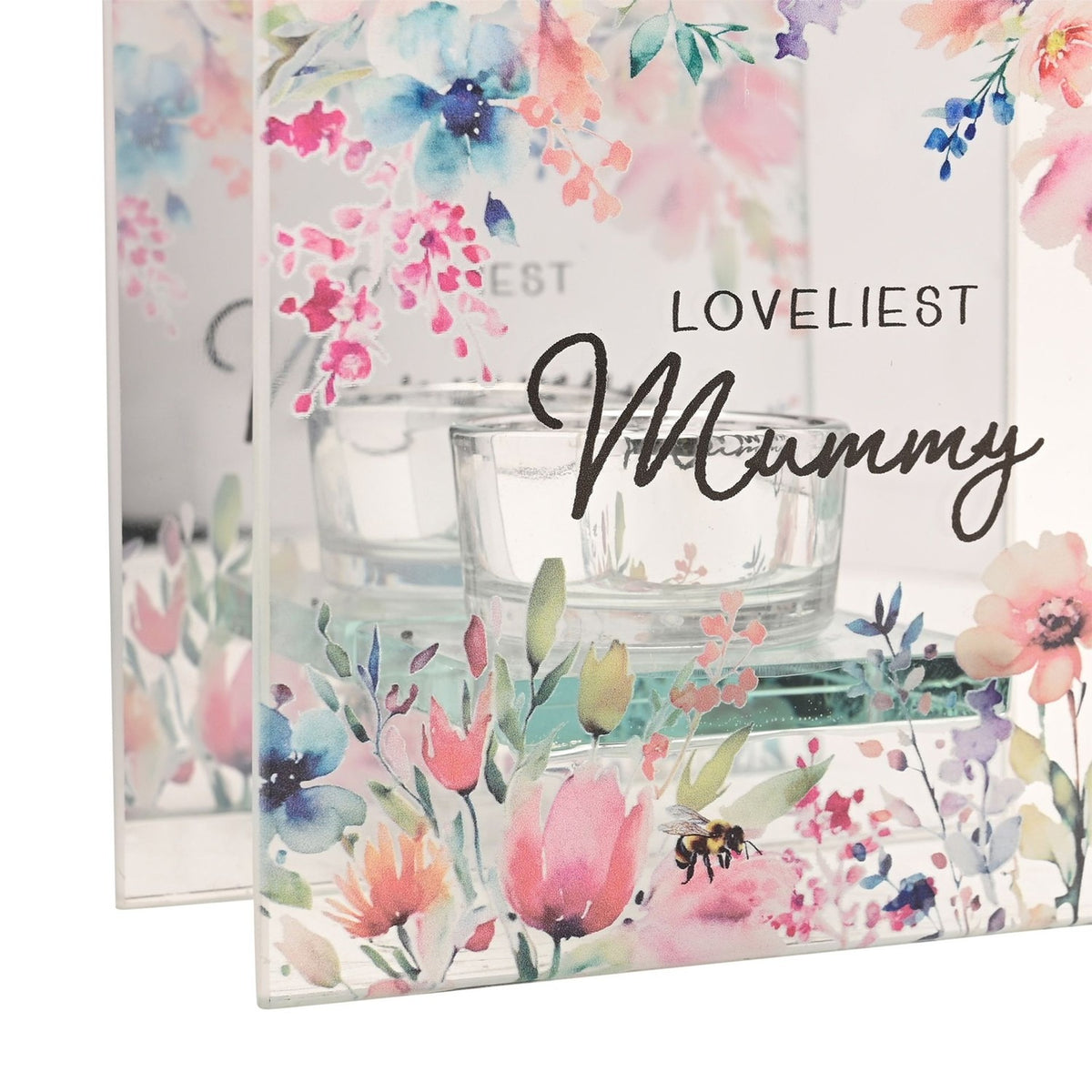 Close-up of the Loveliest Mummy glass tealight candle holder, clear glass panels printed with pastel floral watercolour design and a small bumblebee, with a clear glass tealight cup visible.