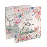 Square glass tealight candle holder with "Loveliest Friend" script, floral watercolour design in pink, blue and peach, clear round tealight cup on a glass ledge, plain white background.