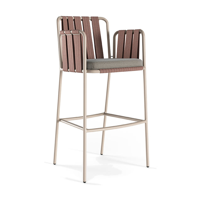 Teja Rope Outdoor Bar Stool with arms, featuring a beige aluminium frame, hand-woven brown rope backrest and sides, and a grey seat cushion, shown on a plain white background.