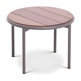 Teja round aluminium garden side table, Ø60cm, with slatted wood-effect top and grey powder-coated frame on four round legs, shown on a plain white background.
