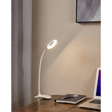 Telarne Clamp Lamp 42cm in white plastic with flexible gooseneck and ring-shaped LED head, clipped to a desk beside a notebook and laptop in a study.