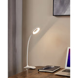 Telarne Clamp Lamp 47cm in white plastic with flexible gooseneck arm and ring-shaped LED head, clamped to a desk edge beside a notebook and laptop.