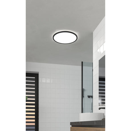 Testara-E LED Flush Ceiling Light, 30cm round fixture with black rim and white diffuser, shown illuminated in a bathroom with white tiled walls.