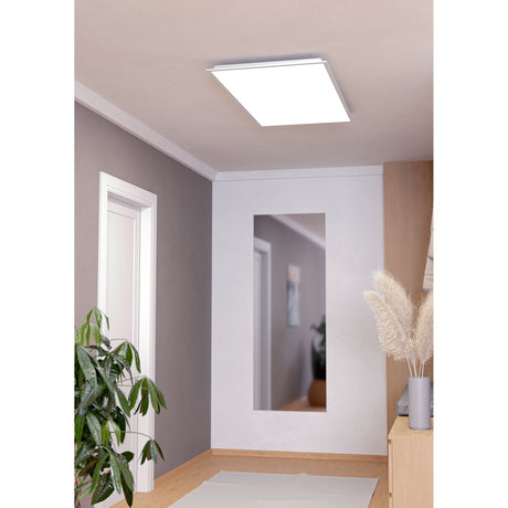 Tesvelle LED Panel Light, a slim rectangular white ceiling fixture with a flat diffuser, shown recessed into a hallway ceiling above a mirrored alcove.