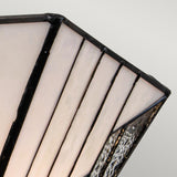 Close-up of a modern geometric lampshade featuring a white opaque surface with black metal framing, highlighting a textured glass accent that evokes an art deco style similar to the Vintage Bronze finish of the Alderley 2 Light Wall Uplighter.