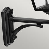 The Turin Large Outdoor 1 Light Up Wall Lantern - Black features a black metal wall-mounted bracket that supports a rectangular lamp fixture with a glass panel. Made from die-cast aluminum, this lantern comes with an IP54 rating. Its design seamlessly combines decorative curves and straight lines, offering a classic and elegant appearance.