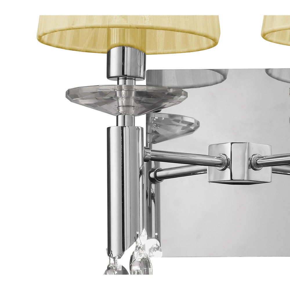 Close-up of Tiffany 2 light crystal wall light showing polished chrome arms, faceted crystal discs, cream fabric shades, and chrome backplate detail.