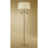 The Tiffany 6 Light Crystal Floor Lamp features a slim gold stand, cream round shade, and elegant crystal accents, set against a neutral beige background.