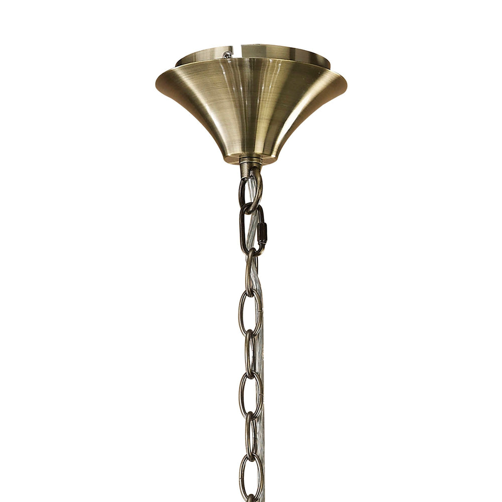 Close-up of the Tiffany chandelier's antique brass ceiling rose and suspension chain against a plain white background.