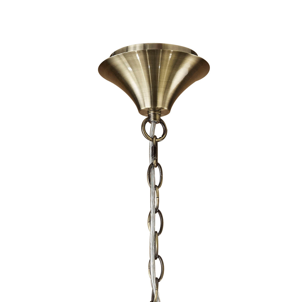 Close-up of the antique brass ceiling rose and chain suspension on the Tiffany 6 light crystal chandelier, shown against a plain white background.