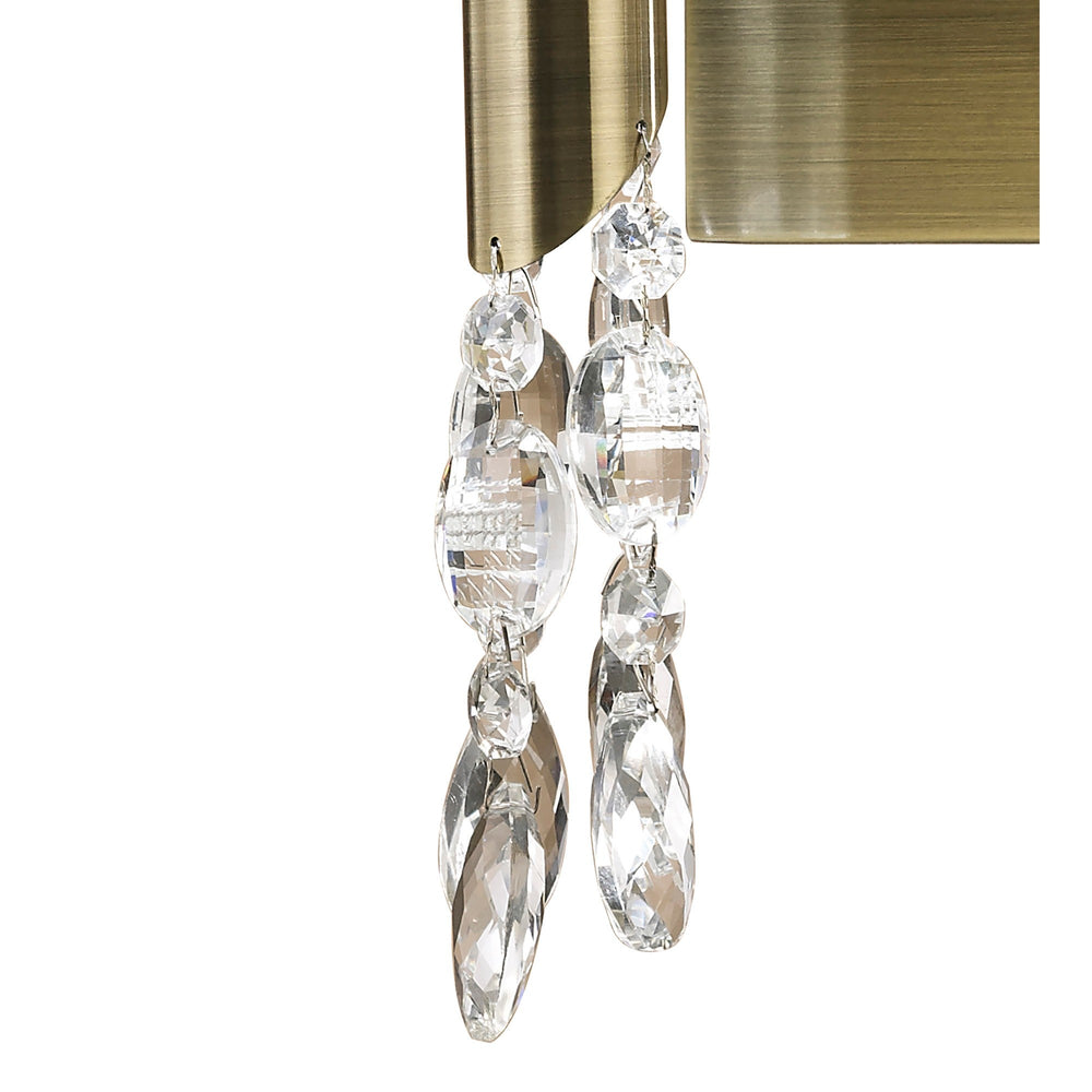 Close-up of crystal droplet strands hanging beneath the antique brass arms of the Tiffany 2 Light Crystal Wall Light.