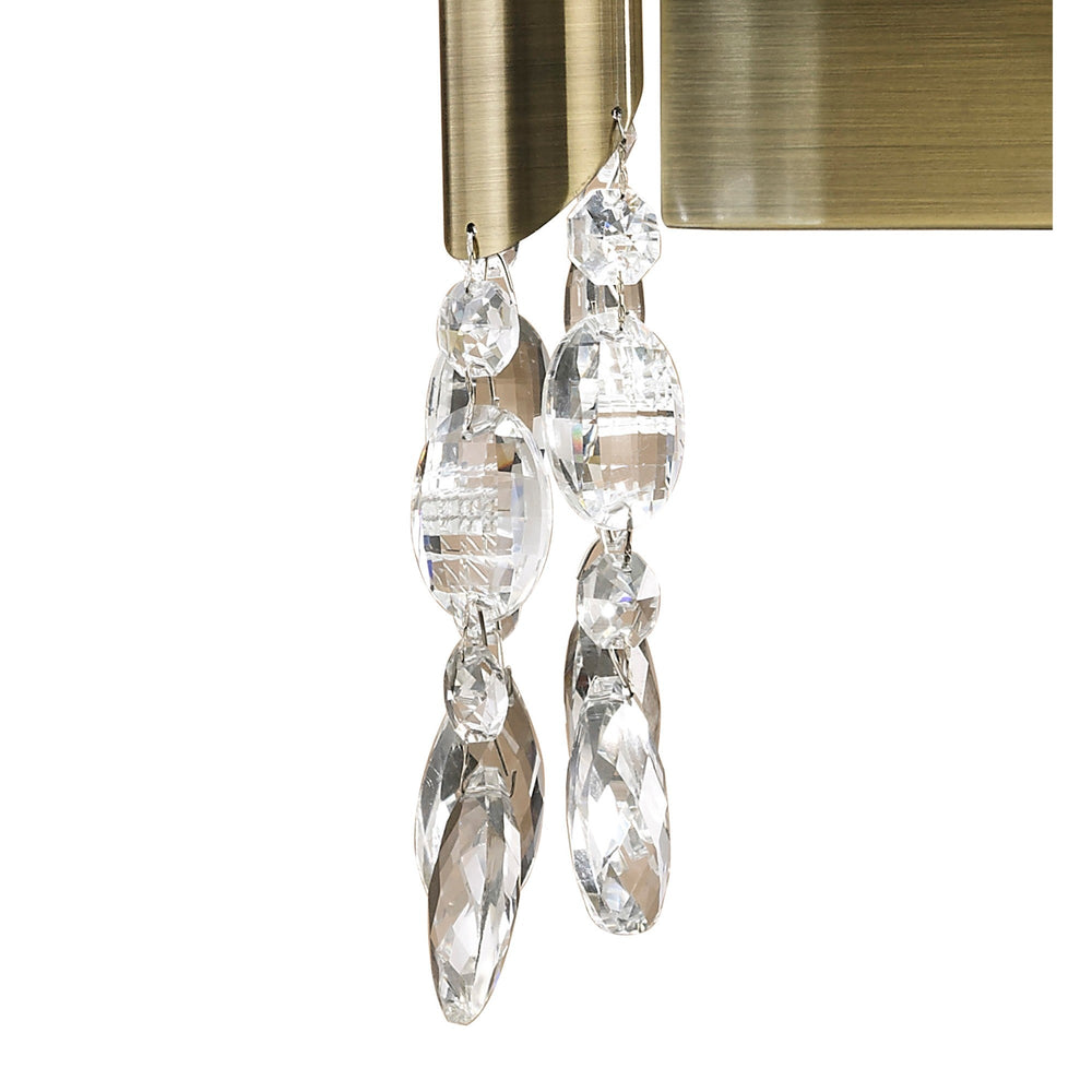 Close-up of Tiffany wall light showing antique brass base with two strands of faceted crystal droplets hanging beneath the white fabric shades.