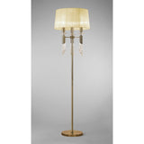 The Tiffany 6 Light Crystal Floor Lamp features a brass finish, cream pleated shade, and elegant crystal accents for stylish lighting against a plain gray background.