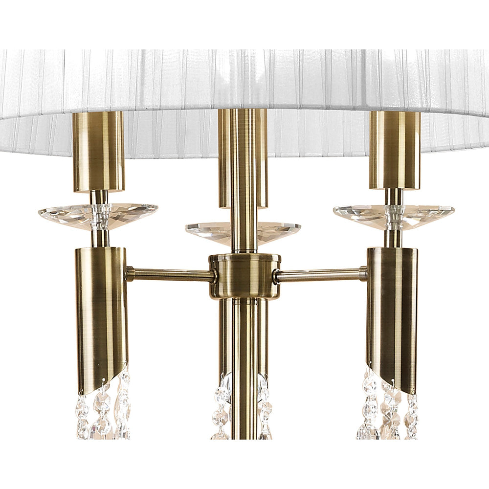 Close-up of the Tiffany 3 Light Crystal Floor Lamp in brass with a white shade, featuring three candle-style arms, crystal accents, and decorative glass elements for an elegant modern look.