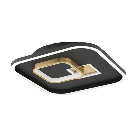 Tiriolo LED ceiling panel light shown at an angle, square black frame with glowing white edge and a brushed gold ring and crackle-effect insert at centre, on a white background.