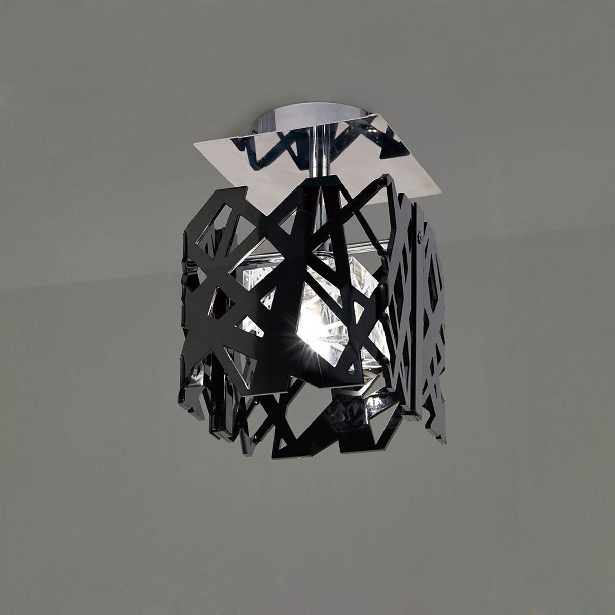 Mantra Tokio semi-flush ceiling light with laser-cut black acrylic geometric cage, central crystal shade, and polished chrome square canopy.