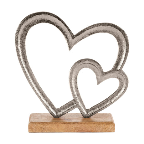 Tomamae Decorative Heart ornament with two interlocking open heart outlines in textured silver aluminium, mounted on a rectangular natural mango wood base, shown on a white background.