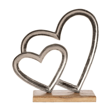 Tomamae Decorative Hearts sculpture with two overlapping open heart outlines in textured silver aluminium, set on a rectangular mango wood base, shown against a plain white background.