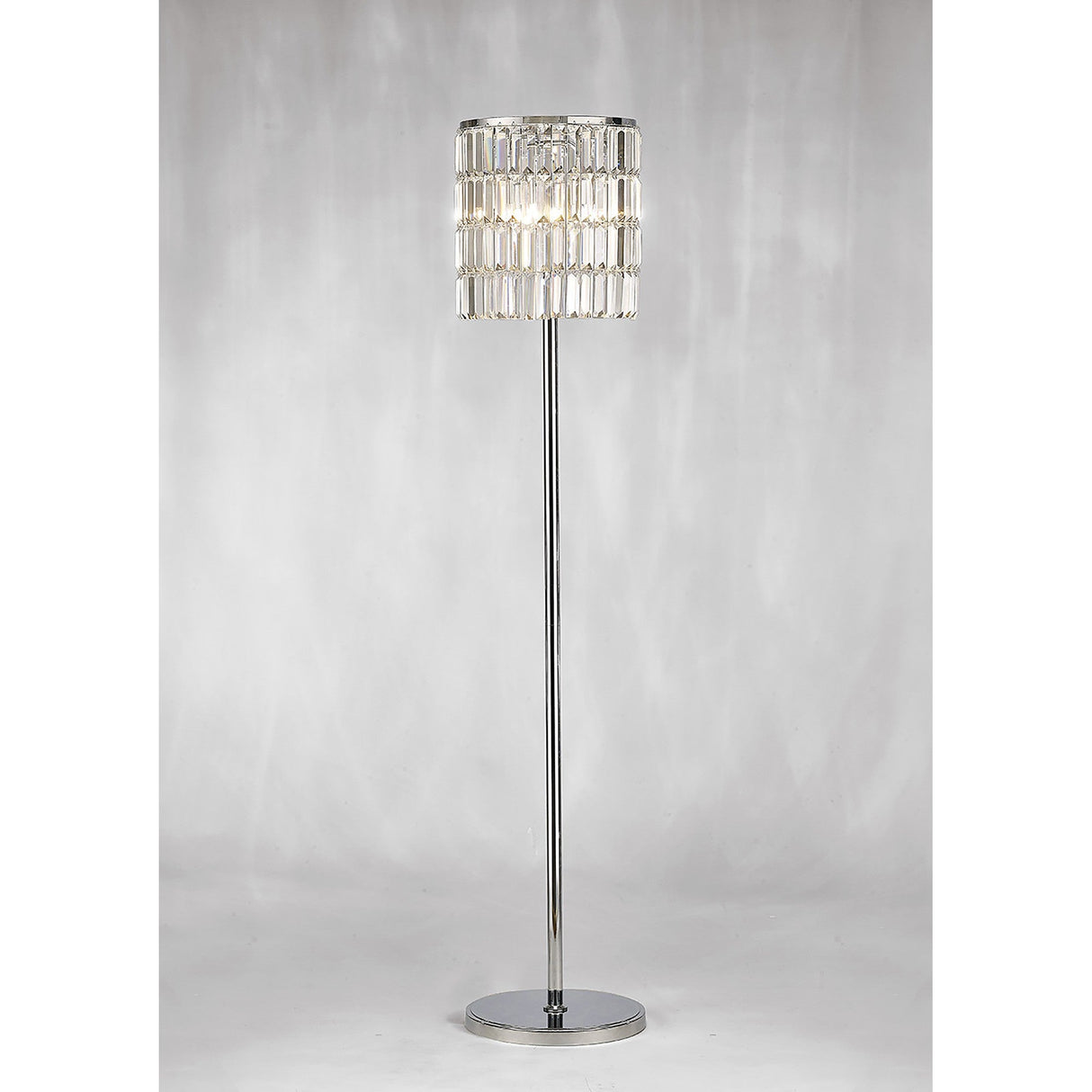 The Torre 5 Light Crystal Curtain Floor Lamp in Polished Chrome features a modern design with a cylindrical shade of layered rectangular glass, set against a light gray background—ideal for making a statement in any space.