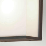 A close-up of the Torsten 1 Light Outdoor Large Wall Light in a graphite finish showcases its modern, square shape with a frosted glass cover and sleek metallic edges, softly illuminating the area. The image highlights its clean lines and minimalist design.