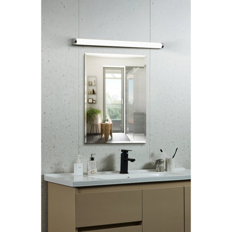 Tragacete 1 LED Bathroom Wall Light, a slim 60cm tubular bar in silver and chrome with a white diffuser, mounted above a rectangular mirror in a bathroom vanity setting.