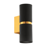 Tramena Wall Light 6cm in matt black steel with two cylinder shades joined by a polished gold band on a gold rectangular backplate, shown on a plain white background.