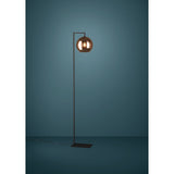 Trelbette Floor Lamp in black steel with a single copper globe glass shade on a right-angled arm, square base, shown against a dark teal background.