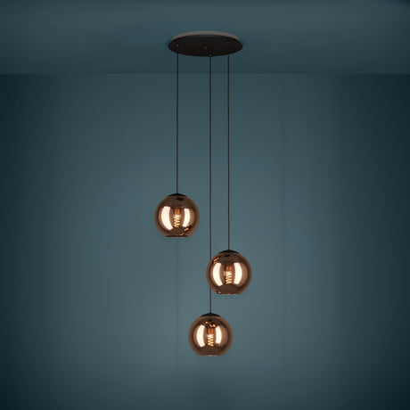 Trelbette Glass 3 Light Pendant in Black, three copper-toned glass globes at staggered heights on black cables from a round ceiling plate, shown against a dark teal background.