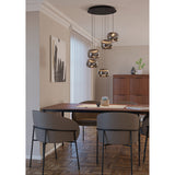 Hortunas five-light cluster pendant with round black steel canopy and staggered smoked glass shades on varied cables, shown above a dining table.