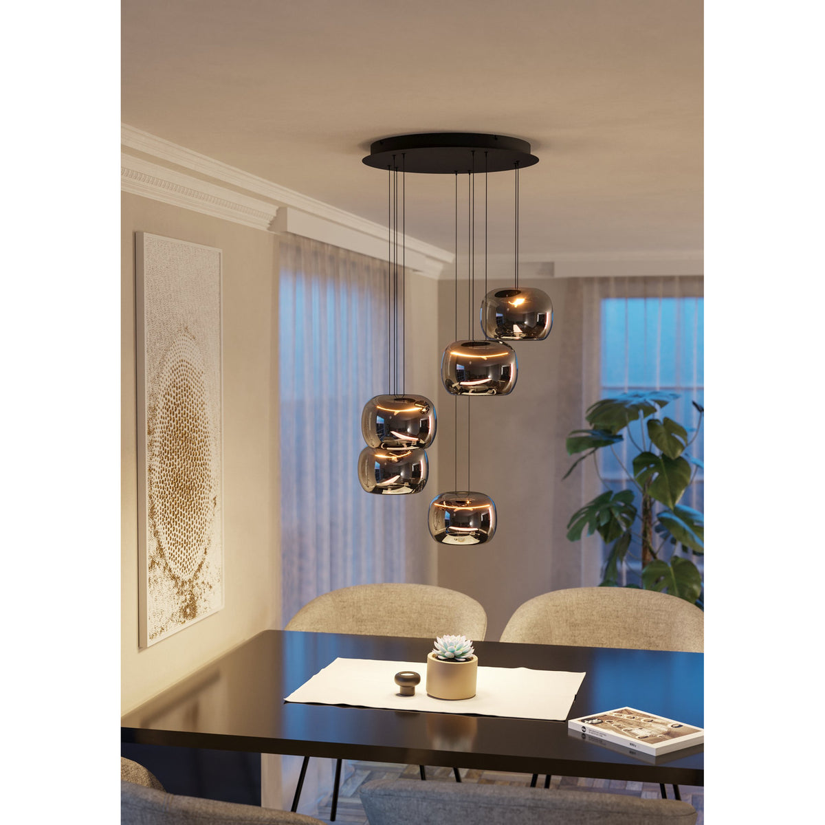 Hortunas five-light cluster pendant with round black ceiling canopy and smoked glass shades on staggered cables, shown lit above a dining table.