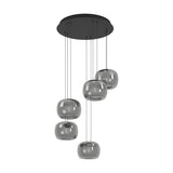 Hortunas 5-light cluster pendant with round black steel ceiling canopy and smoked glass shades at staggered cable lengths, shown on a plain white background.