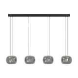 Hortunas linear pendant light with a black steel ceiling bar and four rounded smoked glass shades suspended on fine cords, shown on a plain white background.