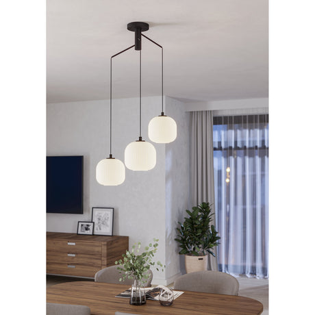 Trolmane Glass 3 Light Pendant in Black, with three ribbed white glass globe shades on black steel arms and canopy, shown hanging above a dining table in a living room setting.