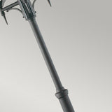 A sleek and modern black Valencia 3 Light Triple Head Lamp Post stands with a slight angle against a light gray background. Its upper section is adorned with decorative, curved elements, adding an elegant touch to outdoor lighting.