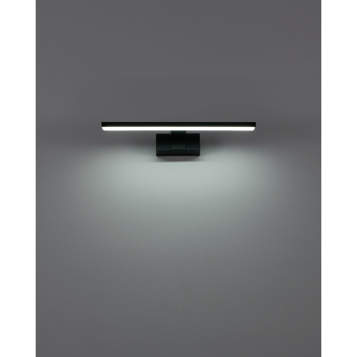 Varette 40cm LED bathroom mirror light in black, a slim aluminium bar on a rectangular wall mount, shown illuminated against a plain grey wall.