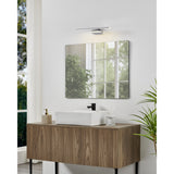 Varette LED Bathroom Mirror Light 40cm in chrome, mounted above a square mirror on a bathroom vanity with wood cabinetry, white sink, and black tap.