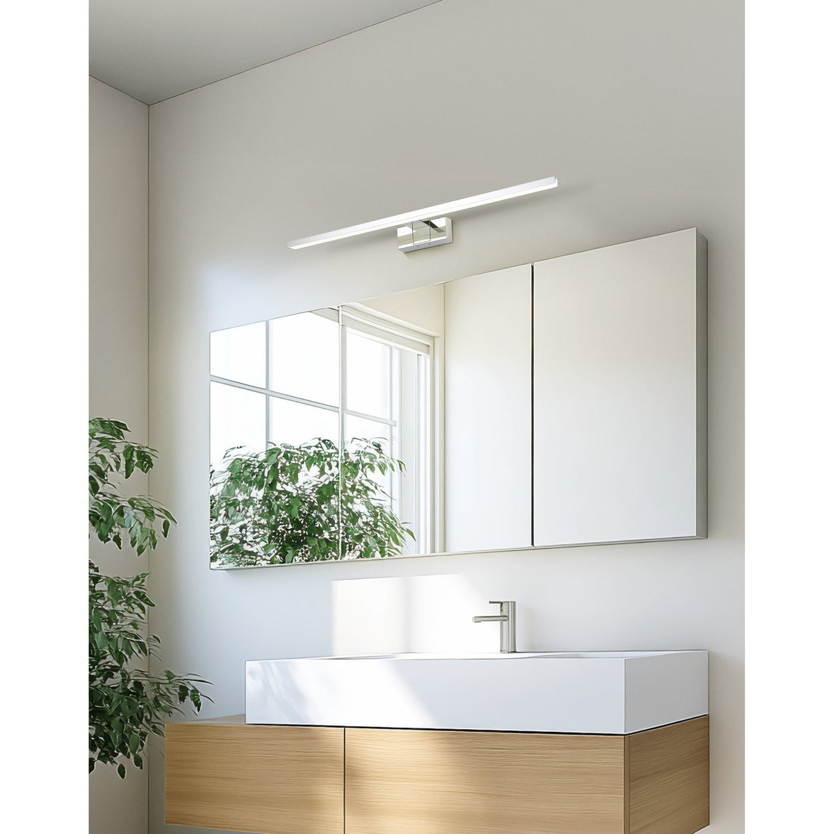 Varette LED Bathroom Mirror Light 60cm in chrome, mounted above a mirrored cabinet in a modern bathroom with a wall-hung timber vanity and basin.