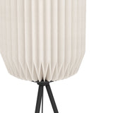 Close-up of the Vavanne Floor Lamp's pleated white paper lantern shade tapering onto a black steel tripod base, shown on a plain white background.