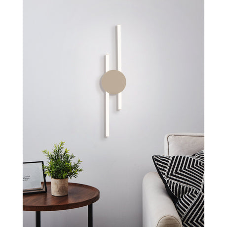 Venticello LED Flush Ceiling Light in sand finish, two offset linear LED bars with a round disc centrepiece, mounted on a wall above a sofa in a living room.