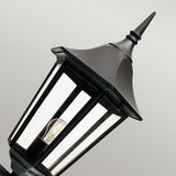 Introducing the Valencia Outdoor Large 1 Light Up Lantern in classic black, expertly crafted from die-cast aluminium with a pointed top design. It features clear glass panels and a visible bulb inside, all set against a plain gray backdrop. With an IP54 rating, this lantern guarantees durability and weather resistance.