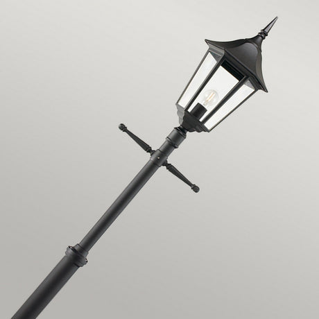 The Valencia Large 1 Light Signal Post - Black, crafted from die-cast aluminium, features a classic lantern design with clear glass panels. Set against a plain gray background and angled slightly to the right, this street lamp post beautifully showcases its elegant and timeless ornamental features that exude vintage appeal.