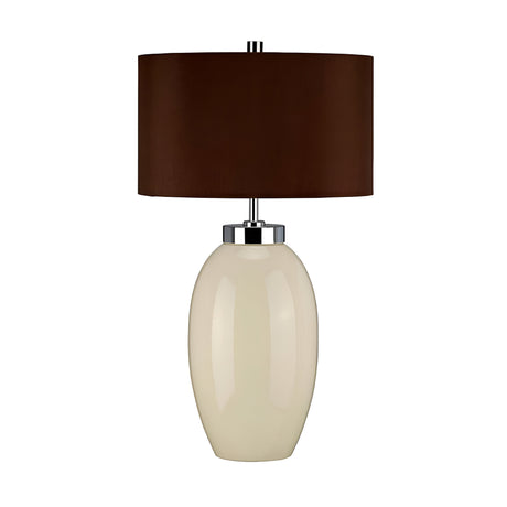 Introducing the Victor 1 Light Small Table Lamp in Cream, showcasing a glossy white ceramic base with an elegant oval shape. It's topped with a sleek dark brown faux silk cylindrical lampshade, all seamlessly connected by a modern metal accent.