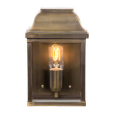 The aged brass of the Victoria 1 Light Outdoor Wall Light amplifies its vintage charm, featuring an exposed filament bulb that emits a warm glow. Its square form and decorative top exude a classic, antique style suitable for any setting. With an IP44 rating, it is ideal for outdoor use thanks to its weather resistance.