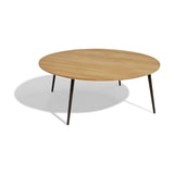 Vint Round Aluminium Outdoor Coffee Table in 110cm, featuring a light wood-finish round top on slim tapered dark metal legs, shown on a plain white background.