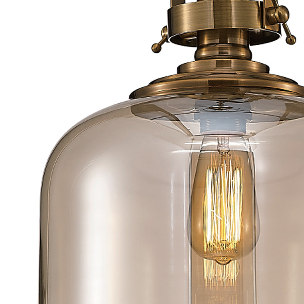 Close-up of Vintage 33cm Bell pendant light showing amber-tinted glass bell shade, antique brass hinged frame, and exposed E27 filament bulb.