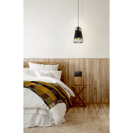 Vivessa fabric pendant light in black, 16.5cm wire cage shade with gold-lined interior, hanging above a wooden bedside table in a bedroom setting.