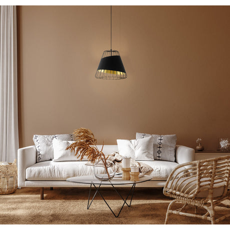 Vivessa Fabric Pendant Light 36cm in black, with gold-lined tapered shade and exposed steel wire cage, hanging above a white sofa in a living room setting.