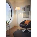 Vorbine mother and child floor lamp in satin nickel with a white fabric shade and gooseneck reading arm, shown beside a black armchair in a living room.